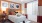 a bedroom with a bed and a lamp