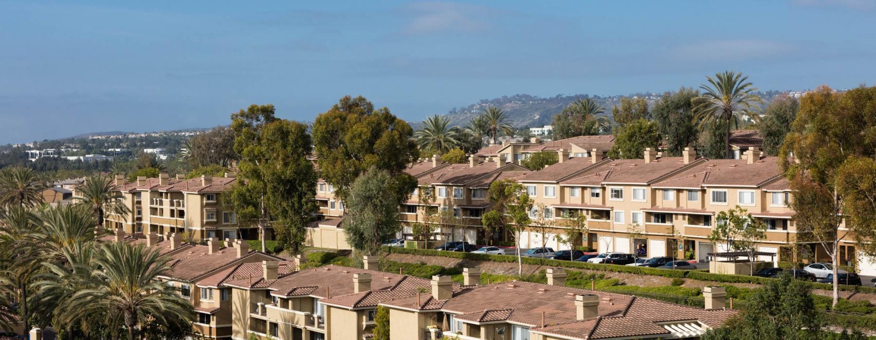 a group of houses with trees in the front