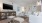 a living room with white furniture and tv