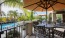 patio with umbrellas with view of a pool