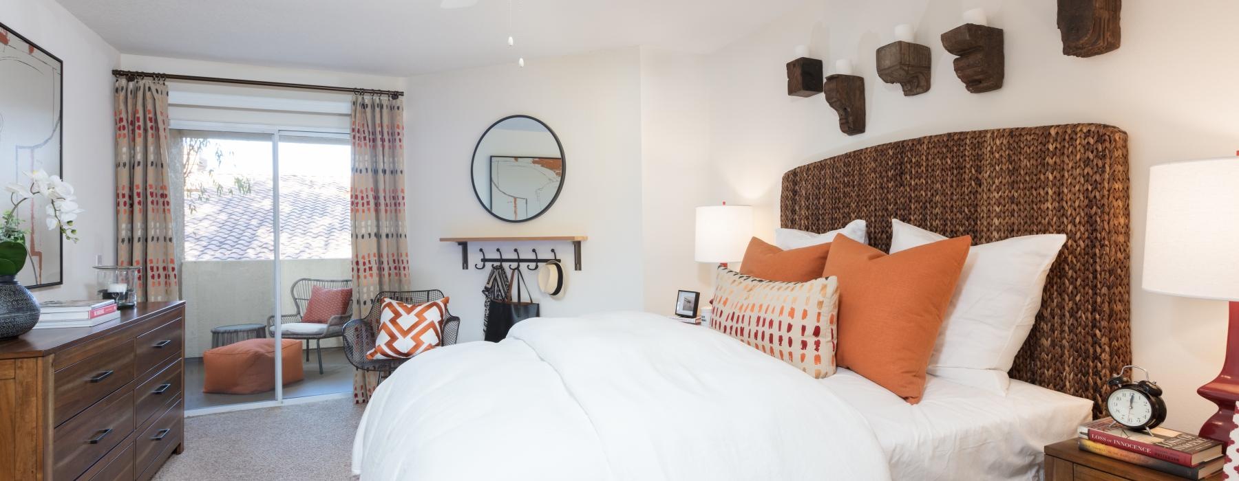 a bedroom with a bed and a fan