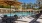 a pool with chairs and umbrella