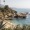 coastal area with beach palm trees and people playing in a ocean