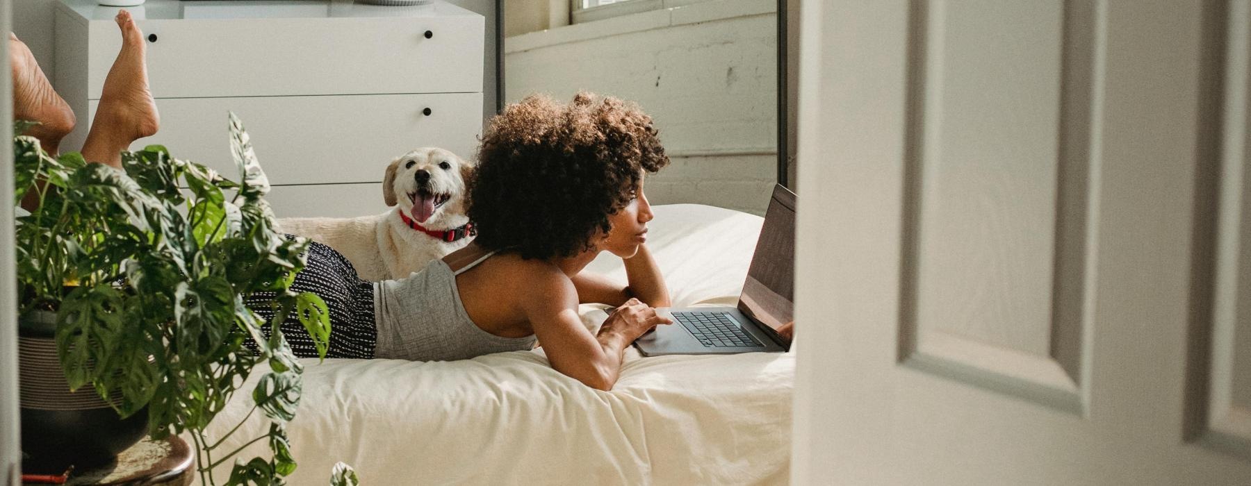 a person and a dog on a bed