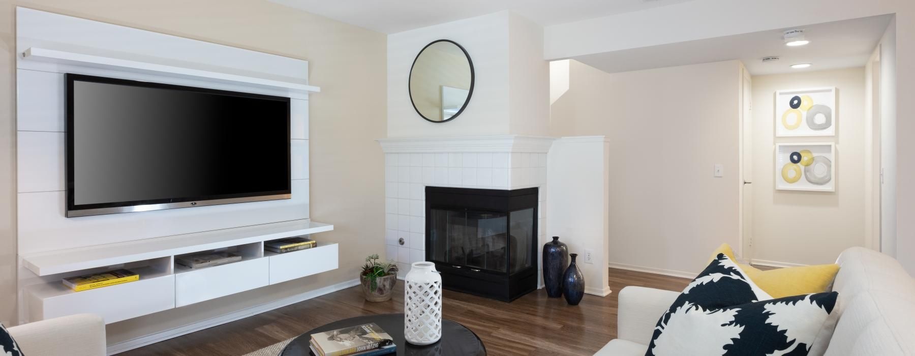 a living room with a fireplace and tv