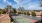 a tennis court with trees and buildings